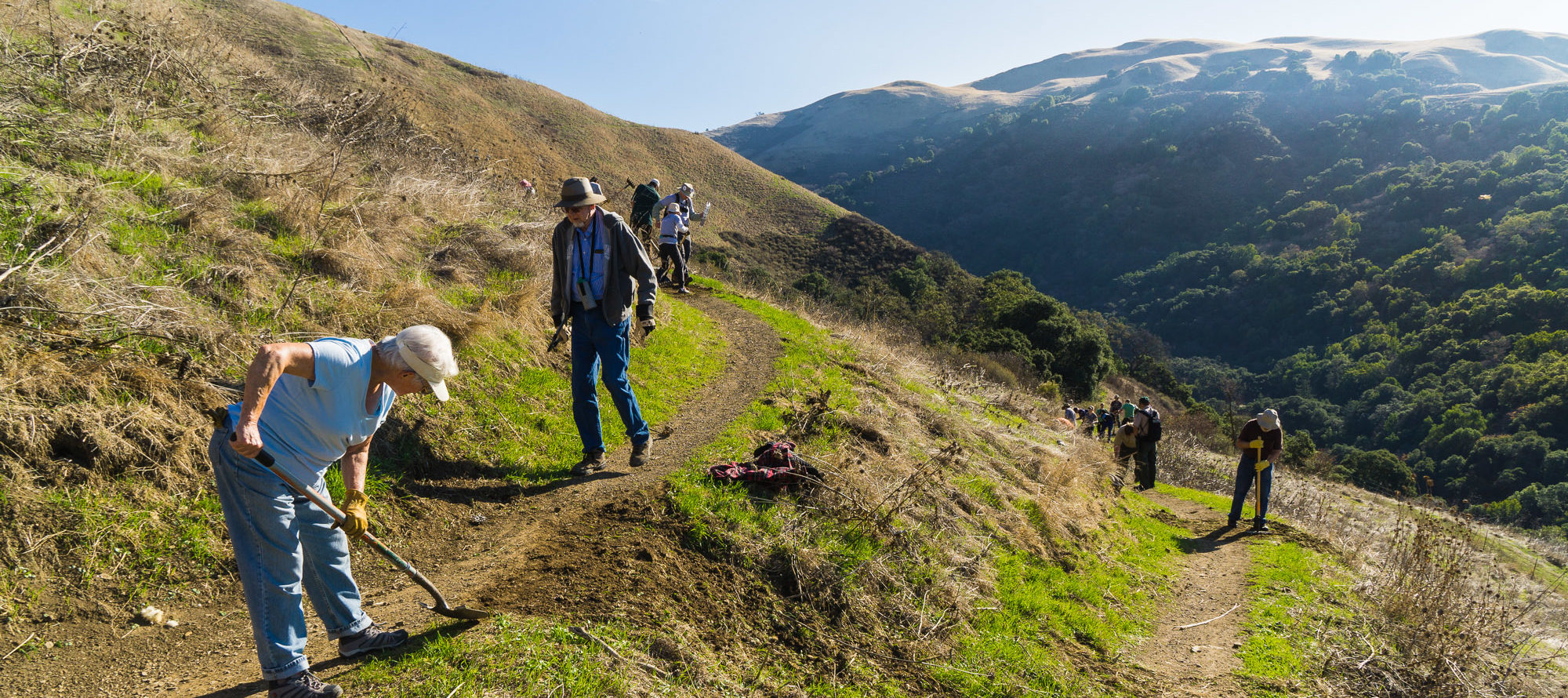 people working with tools on trail